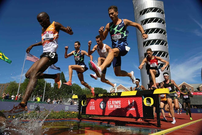 Jun 25, 2021; Eugene, OR, USA; A general overall view as Hillary Bor, Daniel Michalski, Isaac Updike and Mason Ferlic race over the water jump in the steeplechase during the US Olympic Team Trials at Hayward Field. Mandatory Credit: Kirby Lee-USA TODAY Sports