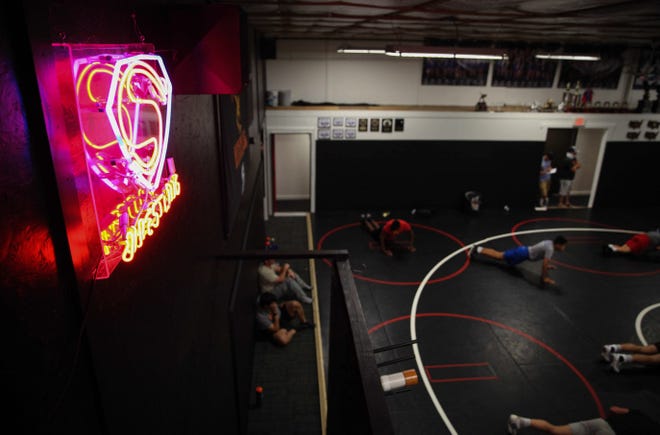 Wrestlers at the Sebolt Wrestling Academy warm up prior to the start of practice on Tuesday, July 13, 2021, at the Grant Robbins Fieldhouse in Jefferson.