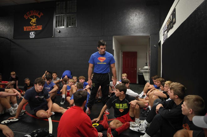 T.J. Sebolt, owner and head coach of the Sebolt Wrestling Academy, talks to his wrestlers during practice in the wrestling room of the Grant Robbins Fieldhouse in Jefferson on Tuesday, July 13, 2021.