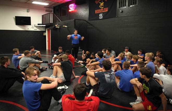 T.J. Sebolt, owner and head coach of the Sebolt Wrestling Academy, speaks with his wrestlers during practice in the wrestling room of the Grant Robbins Fieldhouse in Jefferson on Tuesday, July 13, 2021.
