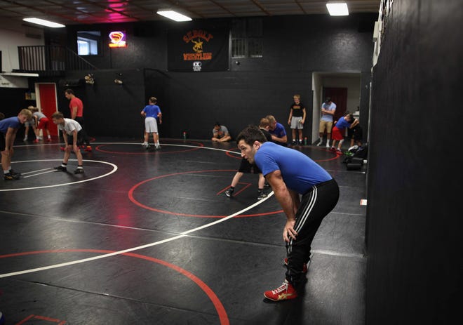 T.J. Sebolt, owner and head coach of the Sebolt Wrestling Academy, coaches his wrestlers during practice in the wrestling room of the Grant Robbins Fieldhouse in Jefferson on Tuesday, July 13, 2021.