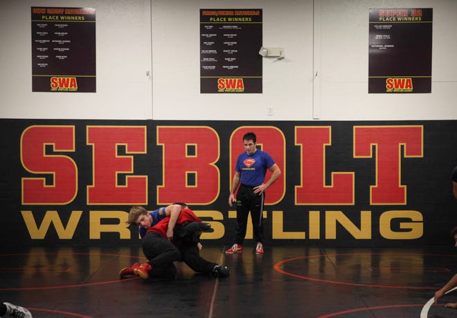 T.J. Sebolt, owner and head coach of the Sebolt Wrestling Academy, watches as his wrestlers work on technique during practice in the wrestling room of the Grant Robbins Fieldhouse in Jefferson on Tuesday, July 13, 2021.