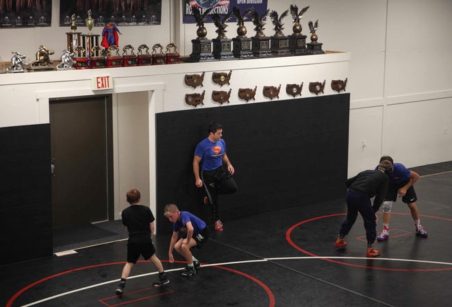 T.J. Sebolt, owner and head coach of the Sebolt Wrestling Academy, watches as his wrestlers run drills during practice in the wrestling room of the Grant Robbins Fieldhouse in Jefferson on Tuesday, July 13, 2021.