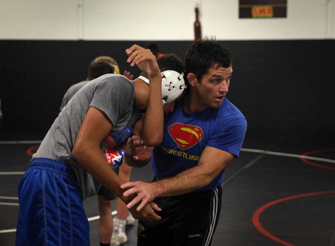 T.J. Sebolt, owner and head coach of the Sebolt Wrestling Academy, right. coaches his wrestlers during practice in the wrestling room of the Grant Robbins Fieldhouse in Jefferson on Tuesday, July 13, 2021.