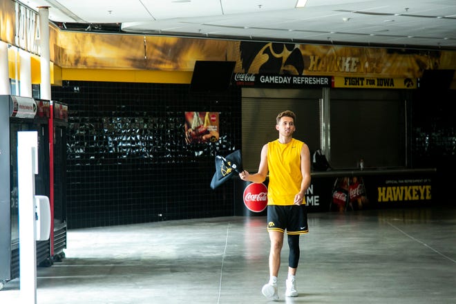 Iowa guard Jordan Bohannon walks along the concourse before talking to reporters during a Hawkeyes men's basketball summer media availability, Thursday, July 15, 2021, at Carver-Hawkeye Arena in Iowa City, Iowa.