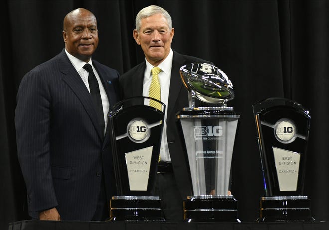 Jul 23, 2021; Indianapolis, Indiana, USA; Iowa Hawkeyes head coach Kirk Ferentz greets Big Ten Conference commissioner Kevin Warren prior to speaking to the media during Big Ten Conference media days at Lucas Oil Stadium.