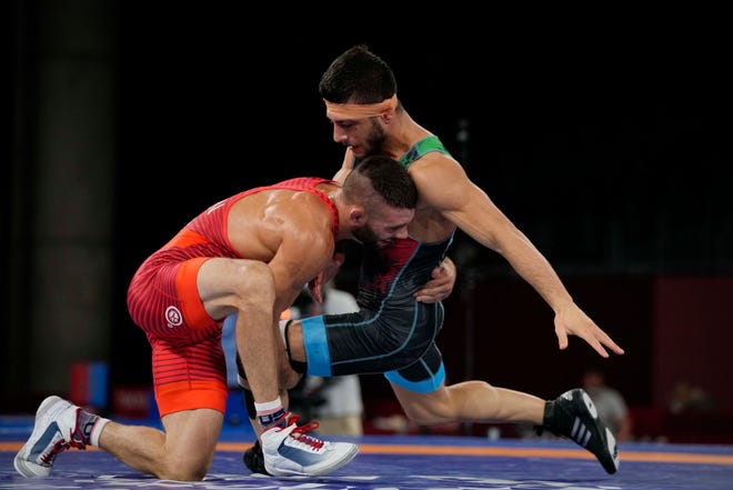 United States' Thomas Patrick Gilman and Iran's Reza Atrinagharchi compete during the men's 53kg Freestyle wrestling bronze medal match at the 2020 Summer Olympics, Thursday, Aug. 5, 2021, in Tokyo, Japan. (AP Photo/Aaron Favila)