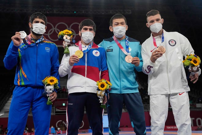 From left, Silver medalist India's Kumar Ravi, Gold medalist Russian Olympic Committee Zavur Uguev,Bronze medalists Kazakhstan's Nurislam Sanayevand United States' Thomas Patrick Gilman celebrate on the podium for the men's 57kg Freestyle wrestling, at the 2020 Summer Olympics, Thursday, Aug. 5, 2021, in Tokyo, Japan. (AP Photo/Aaron Favila)