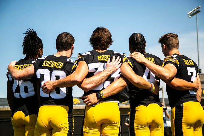 Iowa defensive backs, from left, Kaevon Merriweather, Jack Koerner, Riley Moss, Dane Belton, and Cooper DeJean pose for a photo during Hawkeyes football media day, Friday, Aug. 13, 2021, in Iowa City, Iowa.