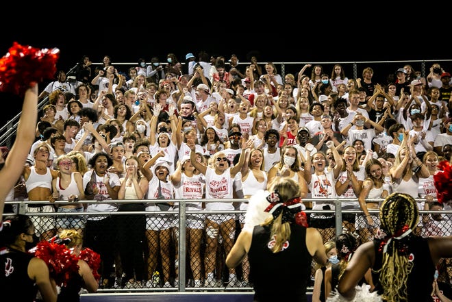 Iowa City High fans cheer during a varsity high school football game, Friday, Aug. 27, 2021, at Liberty High School in North Liberty, Iowa.