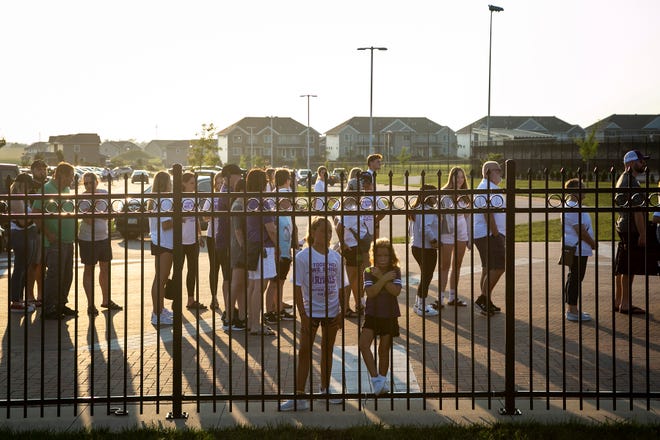 Iowa City Liberty fans wait in line to buy tickets before a varsity high school football game, Friday, Aug. 27, 2021, at Liberty High School in North Liberty, Iowa.