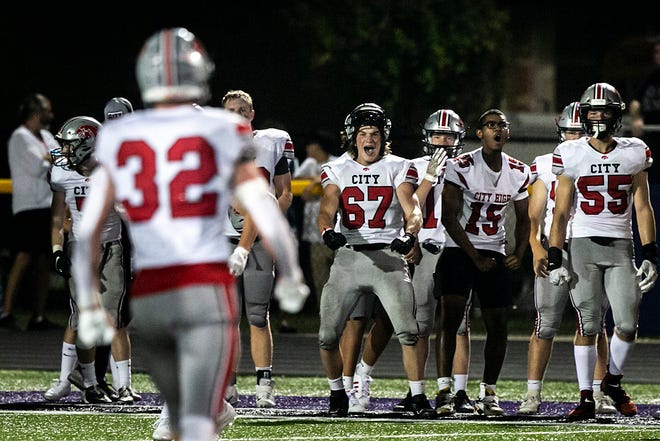 Iowa City High players celebrate a stop from Ben Kueter (32) during a varsity high school football game against Iowa City Liberty, Friday, Aug. 27, 2021, at Liberty High School in North Liberty, Iowa.
