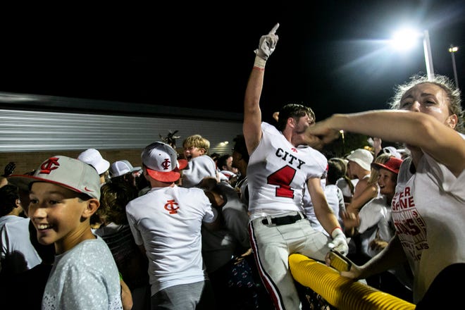 Iowa City High players celebrate with fans after a varsity high school football game against Iowa City Liberty, Friday, Aug. 27, 2021, at Liberty High School in North Liberty, Iowa. The Little Hawks beat the Lightning, 41-0.