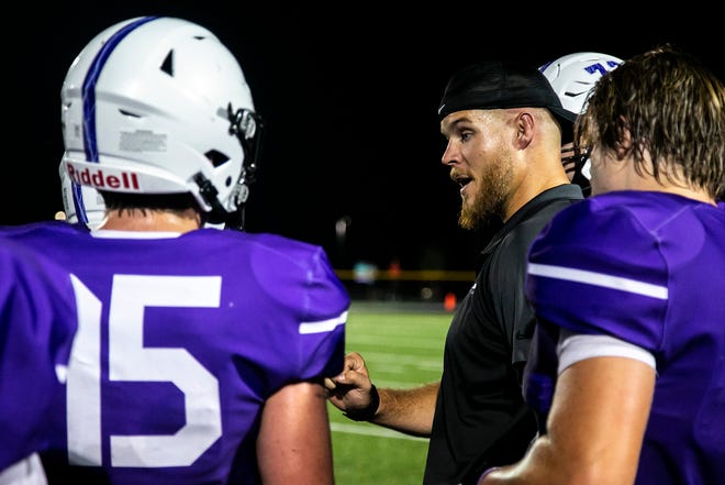 Iowa City Liberty assistant coach Landan Paulsen talks with players during a varsity high school football game against Iowa City High, Friday, Aug. 27, 2021, at Liberty High School in North Liberty, Iowa.