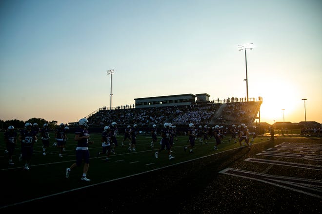 Iowa City Liberty players warm up before a varsity high school football game, Friday, Aug. 27, 2021, at Liberty High School in North Liberty, Iowa.