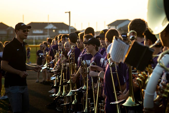 Iowa City Liberty assistant band director Ryan Arp talks with the marching band before a varsity high school football game against Iowa City High, Friday, Aug. 27, 2021, at Liberty High School in North Liberty, Iowa.