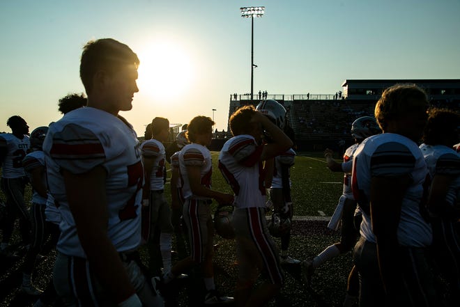 Iowa City High Little Hawks players warm up before a varsity high school football game against Iowa City Liberty , Friday, Aug. 27, 2021, at Liberty High School in North Liberty, Iowa.