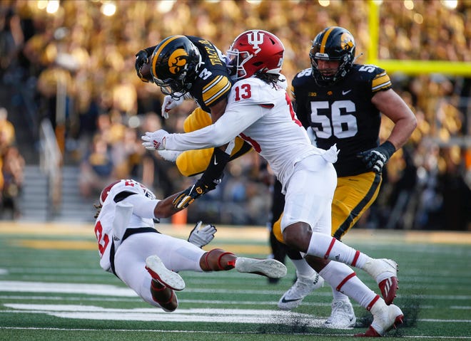 Iowa junior receiver Tyrone Tracy, Jr., hurdles Indiana cornerback Reese Taylor as he runs for extra yards in the fourth quarter at Kinnick Stadium in Iowa City on Saturday, Sept. 4, 2021.