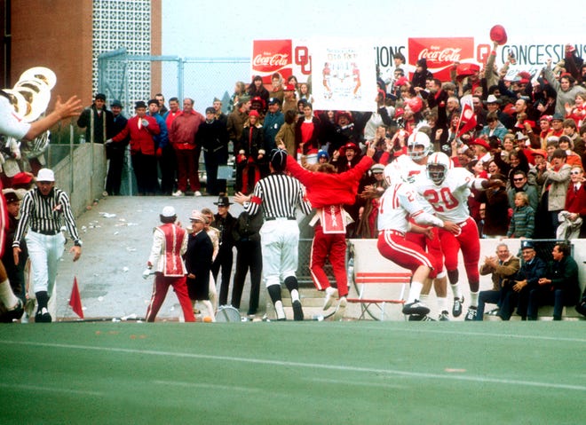 FILE - In this Nov. 25, 1971, file photo, Nebraska's Johnny Rodgers (20) celebrates in the end zone after his long punt return against Oklahoma in Norman, Okla., on Thanksgiving Day. The game on Thanksgiving 50 years ago is back in the spotlight as Nebraska and Oklahoma renew their rivalry on Saturday, Sept. 18, 2021. (Lincoln Journal Star via AP, File) ORG XMIT: NELIN903