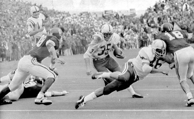 Nebraska halfback Jeff Kinney (35) gets a block from fullback Maury Damkroger (46) on a fourth-down conversion during the 1971 game at OU. Kinney scored four touchdowns in the Huskers' 35-31 win in the Game of the Century.