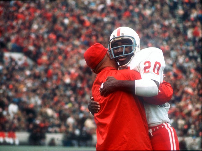 Nebraska's Johnny Rodgers (20) hugs an assistant coach on the sideline after his punt return for a touchdown against Oklahoma in the first quarter of the Cornhuskers' 35-31 win in Norman on Nov. 25, 1971.