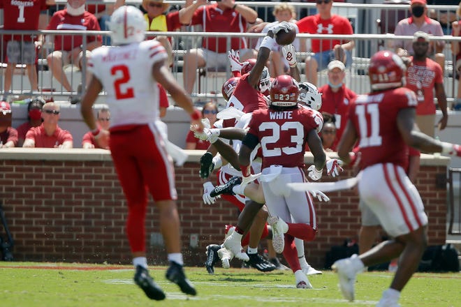 Oklahoma's D.J. Graham (9) intercepts a pass during the fourth quarter of a 23-16 win against Nebraska on Saturday.