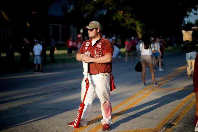 A member of the RUF/NEKS stands before the Okahoma football team arrives for a college football game between the University of Oklahoma Sooners (OU) and the Nebraska Cornhuskers at Gaylord Family-Oklahoma Memorial Stadium in Norman, Okla., Saturday, Sept. 18, 2021.