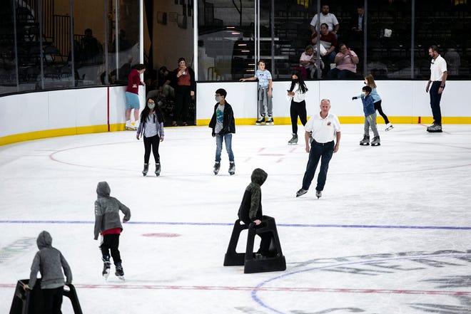 People skate around the hockey rink during an event unveiling the instillation of ice, Tuesday, Sept. 28, 2021, at the Xtream Arena in Coralville, Iowa.