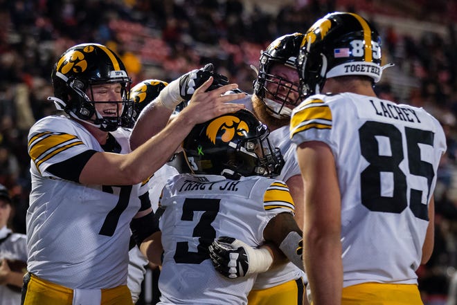 Iowa Hawkeyes wide receiver Tyrone Tracy Jr. (3) celebrates with quarterback Spencer Petras, left, and teammates after scoring a touchdown against the Maryland Terrapins during an NCAA college football game, Friday, Oct. 1, 2021, at Capital One Field at Maryland Stadium in College Park, Maryland.