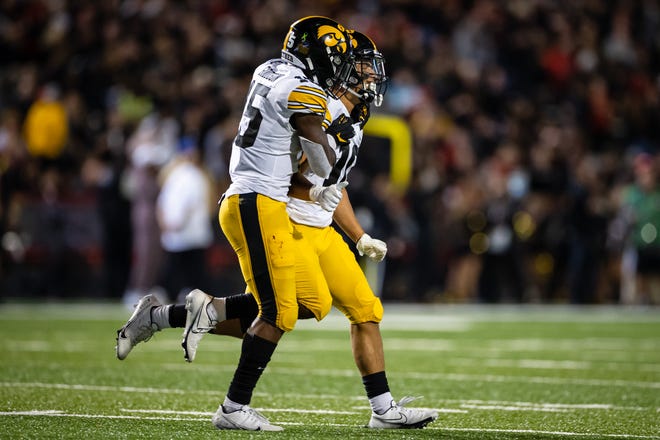 Iowa Hawkeyes wide receiver Arland Bruce IV (10) celebrates with running back Tyler Goodson (15) after scoring a touchdown against the Maryland Terrapins during an NCAA college football game, Friday, Oct. 1, 2021, at Capital One Field at Maryland Stadium in College Park, Maryland.