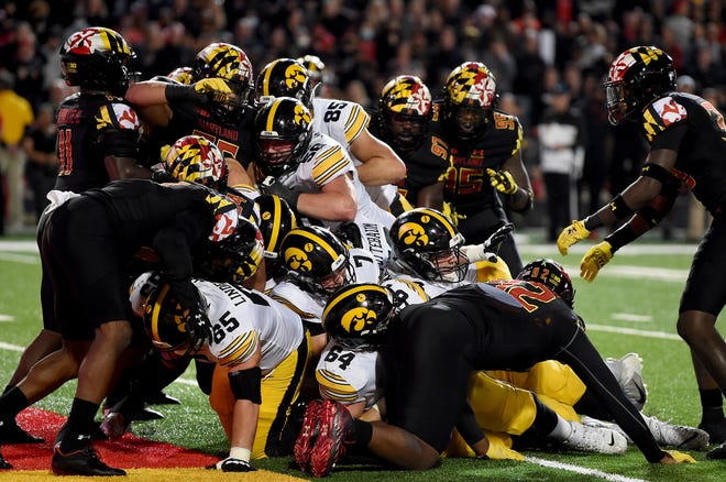 Iowa's Spencer Petras (7) scores a touchdown in the first half on a quarterback sneak during a football game against the Maryland Terrapins, Friday, Oct. 1, 2021, at Capital One Field at Maryland Stadium in College Park, Maryland.