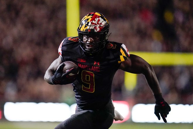 Maryland tight end Chigoziem Okonkwo runs with the ball while scoring on a touchdown catch against Iowa during an NCAA college football game, Friday, Oct. 1, 2021, at Capital One Field at Maryland Stadium in College Park, Maryland.