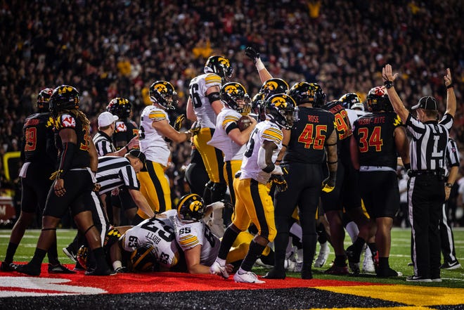 Iowa Hawkeyes quarterback Spencer Petras (7) rushes for a touchdown against the Maryland Terrapins during an NCAA college football game, Friday, Oct. 1, 2021, at Capital One Field at Maryland Stadium in College Park, Maryland.