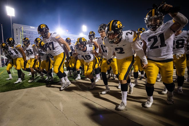 Iowa Hawkeyes players hold hands as they run to the locker after a game against the Maryland Terrapins, Friday, Oct. 1, 2021, at Capital One Field at Maryland Stadium in College Park, Maryland.
