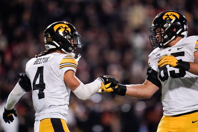 Iowa defensive back Dane Belton, left, celebrates his interception with defensive lineman Logan Lee during an NCAA college football game against Maryland, Friday, Oct. 1, 2021, at Capital One Field at Maryland Stadium in College Park, Maryland.
