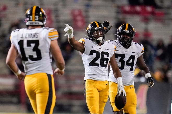 Iowa defensive back Kaevon Merriweather (26) celebrates with Jay Higgins, right, after making an interception on a pass during an NCAA college football game, Friday, Oct. 1, 2021, at Capital One Field at Maryland Stadium in College Park, Maryland.
