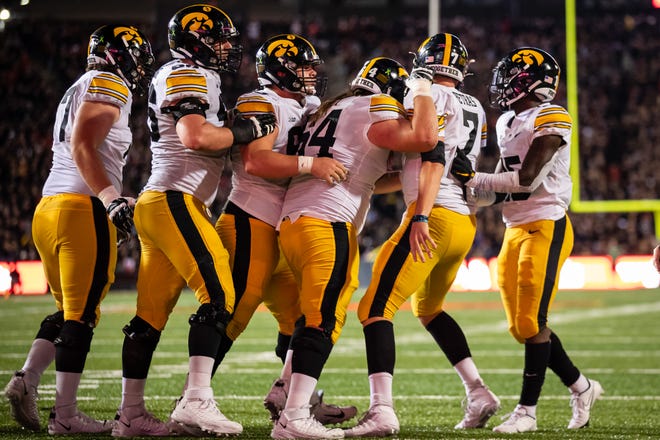 Iowa Hawkeyes quarterback Spencer Petras (7) celebrates with teammates after scoring a touchdown against the Maryland Terrapins during an NCAA college football game, Friday, Oct. 1, 2021, at Capital One Field at Maryland Stadium in College Park, Maryland.