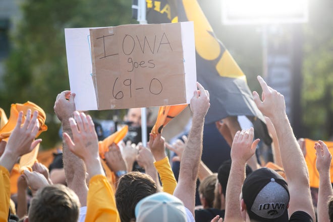 Iowa Hawkeyes fans show off their signs during the Fox Sports Big Noon Kickoff NCAA football pregame show, Saturday, Oct. 9, 2021, at the Pentacrest in Iowa City, Iowa.