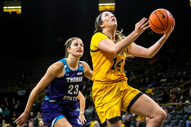 Iowa's McKenna Warnock (14) drives to the basket as Truman State's Maddie Re (23) defends during a NCAA women's basketball exhibition game, Thursday, Nov. 4, 2021, at Carver-Hawkeye Arena in Iowa City, Iowa.