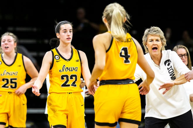 Iowa guard Caitlin Clark (22) and Iowa head coach Lisa Bluder greet Kylie Feuerbach (4) as she comes into the huddle at a timeout during a NCAA women's basketball exhibition game against Truman State, Thursday, Nov. 4, 2021, at Carver-Hawkeye Arena in Iowa City, Iowa.