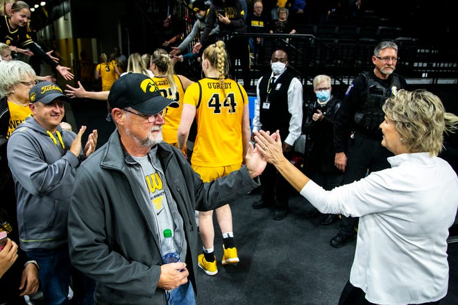 Iowa head coach Lisa Bluder gives a fan a high-five after a NCAA women's basketball exhibition game against Truman State, Thursday, Nov. 4, 2021, at Carver-Hawkeye Arena in Iowa City, Iowa.