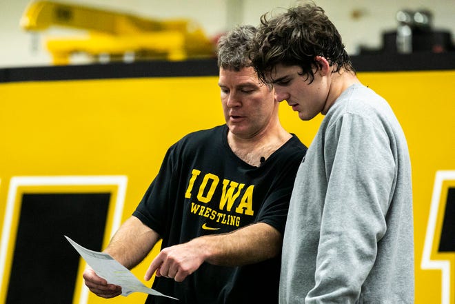 Iowa head coach Tom Brands, left, talks with Abe Assad during a NCAA Hawkeyes men's wrestling intrasquad match, Friday, Nov. 5, 2021, at the Dan Gable Wrestling Complex in Carver-Hawkeye Arena in Iowa City, Iowa.