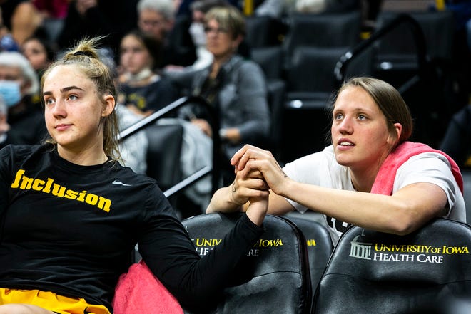 Iowa forward AJ Ediger, left, holds hands with teammate Sharon Goodman during a NCAA women's basketball exhibition game against Truman State, Thursday, Nov. 4, 2021, at Carver-Hawkeye Arena in Iowa City, Iowa.