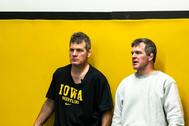 Iowa head coach Tom Brands, left, and associate head coach Terry Brands talk during a NCAA Hawkeyes men's wrestling intrasquad match, Friday, Nov. 5, 2021, at the Dan Gable Wrestling Complex in Carver-Hawkeye Arena in Iowa City, Iowa.