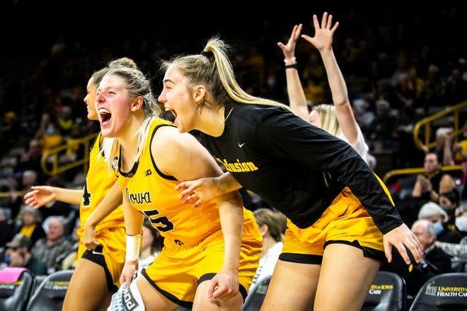Iowa center Monika Czinano and AJ Ediger, right, cheer on teammates from the bench during a NCAA women's basketball exhibition game against Truman State, Thursday, Nov. 4, 2021, at Carver-Hawkeye Arena in Iowa City, Iowa.