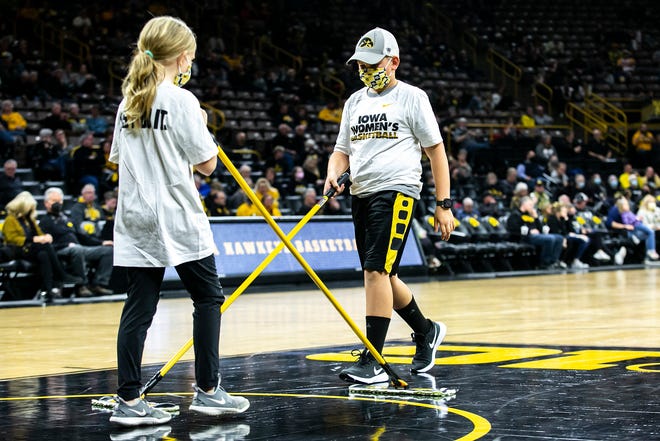 Some young Iowa Hawkeyes sweepers clean off the court during a NCAA women's basketball exhibition game against Truman State, Thursday, Nov. 4, 2021, at Carver-Hawkeye Arena in Iowa City, Iowa.