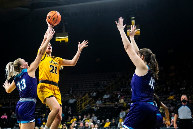 Iowa guard Kate Martin (20) drives to the basket against Truman State's Hannah Belanger (13) and Allison Thomas, right, during a NCAA women's basketball exhibition game, Thursday, Nov. 4, 2021, at Carver-Hawkeye Arena in Iowa City, Iowa.