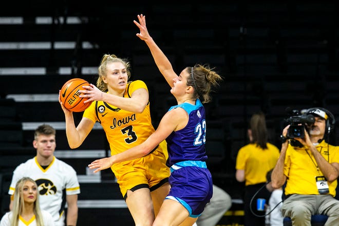 Iowa guard Sydney Affolter (3) passes the ball as Truman State's Maddie Re defends during a NCAA women's basketball exhibition game, Thursday, Nov. 4, 2021, at Carver-Hawkeye Arena in Iowa City, Iowa.