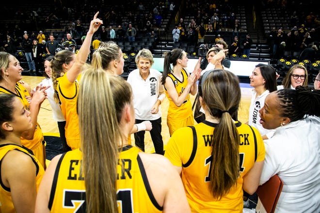 Iowa head coach Lisa Bluder smiles while huddling up with players after a NCAA women's basketball exhibition game against Truman State, Thursday, Nov. 4, 2021, at Carver-Hawkeye Arena in Iowa City, Iowa.