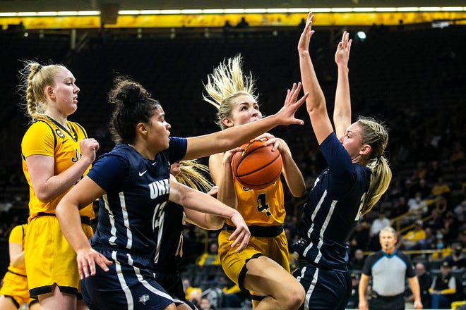 Iowa guard Kylie Feuerbach (4) drives the basket against New Hampshire's Brooke Kane, right, during a NCAA non-conference women's basketball game, Tuesday, Nov. 9, 2021, at Carver-Hawkeye Arena in Iowa City, Iowa.